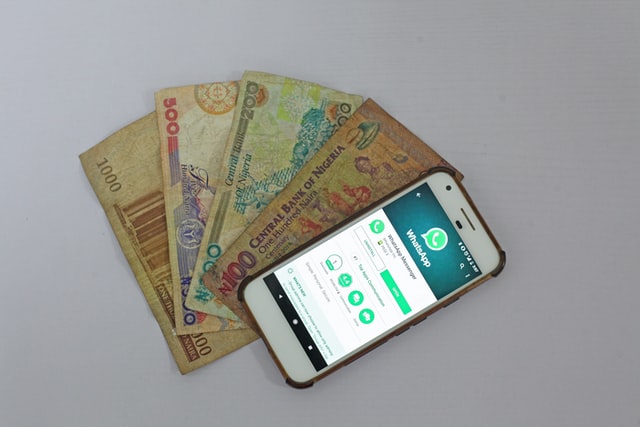 Android smartphone beside banknote