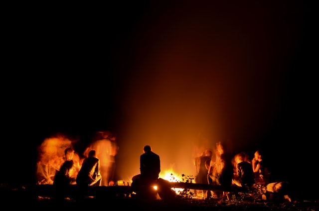 People gathered around camp fire