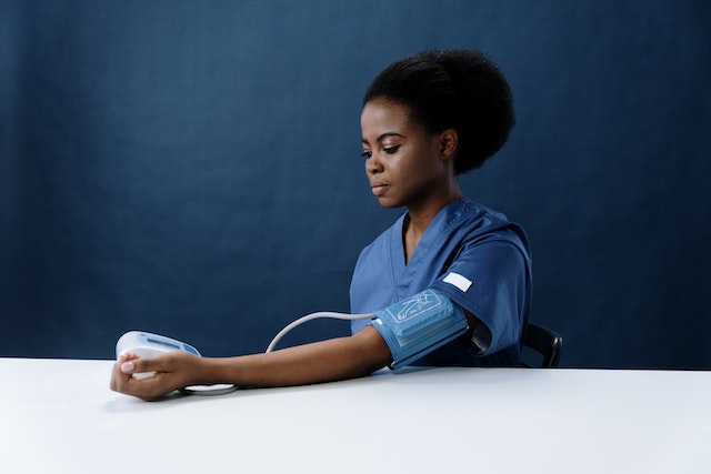 A Healthcare Worker Measuring Her Own Blood Pressure