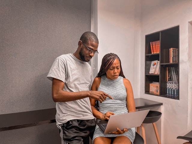 man and woman looking at a laptop