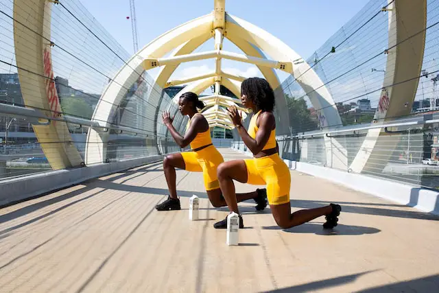 women in yellow shorts exercising