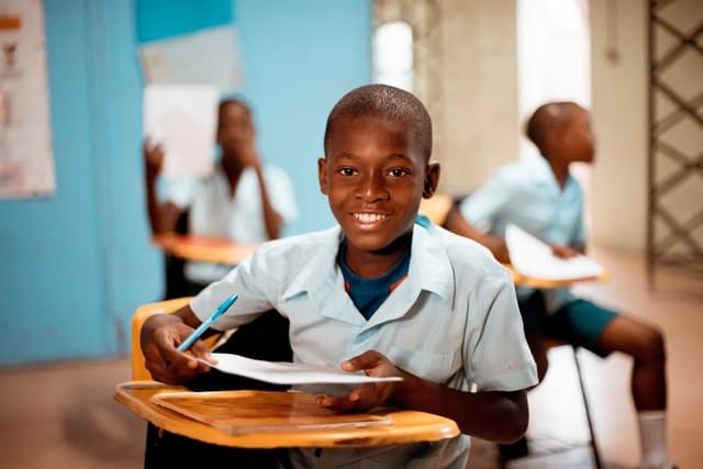 Boy holding a white paper