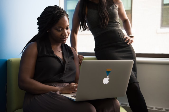 Woman sitting in front of a MacBook