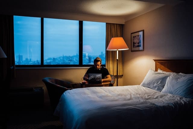 man sits near bed