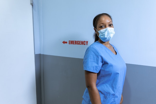 A Woman Wearing a Scrub Suit and Face Mask